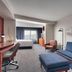 Courtyard by Marriott Johnson City room with sofa, desk, chair, and king bed near a window