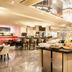 Buffet dining area at Leonardo Royal Hotel Düsseldorf Königsallee in Düsseldorf with chandeliers and food stations