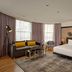 Holmes Hotel London in London: stylish guest room with king bed, sofa seating, and large windows