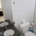 Resort L'acqua Diroma V bathroom with double sink, toilet, and glass shower in Caldas Novas