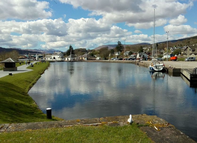 Braeburn Guesthouse in Fort William with harbor view, boats docked on calm water under cloudy skies