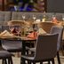 Novotel Campo Grande restaurant with set tables, wine glasses, and upholstered chairs in Campo Grande