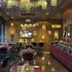 Asdal Boutique Hotel Seef in Manama restaurant with buffet tables and colorful hanging lights