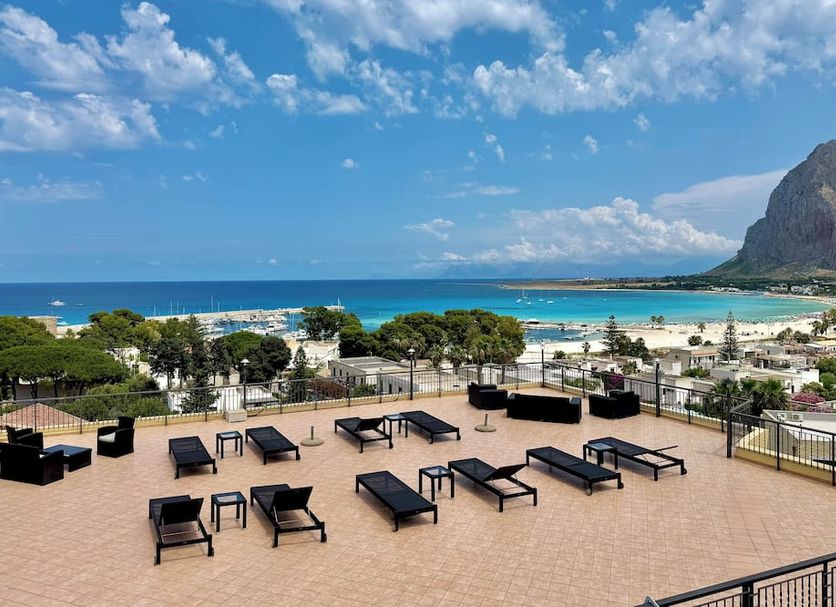 Hotel Panoramic in San Vito Lo Capo rooftop terrace with loungers overlooking beach and sea