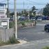 Village Green Motel in South Yarmouth with ocean view across parking lot and coastal road