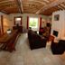 La Ferme de la Gronde in Bayeux: rustic lounge with wood-beamed ceiling, fireplace and seating
