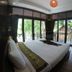 Lipe Sunset Beach Resort in Ko Lipe bedroom with large windows and balcony views of trees