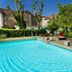 Outdoor hotel pool at Bildungshaus St Bernhard in Rastatt with loungers and garden setting
