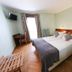 Hotel Sporting, Breuil-Cervinia guest room with double bed, wall TV, and balcony door