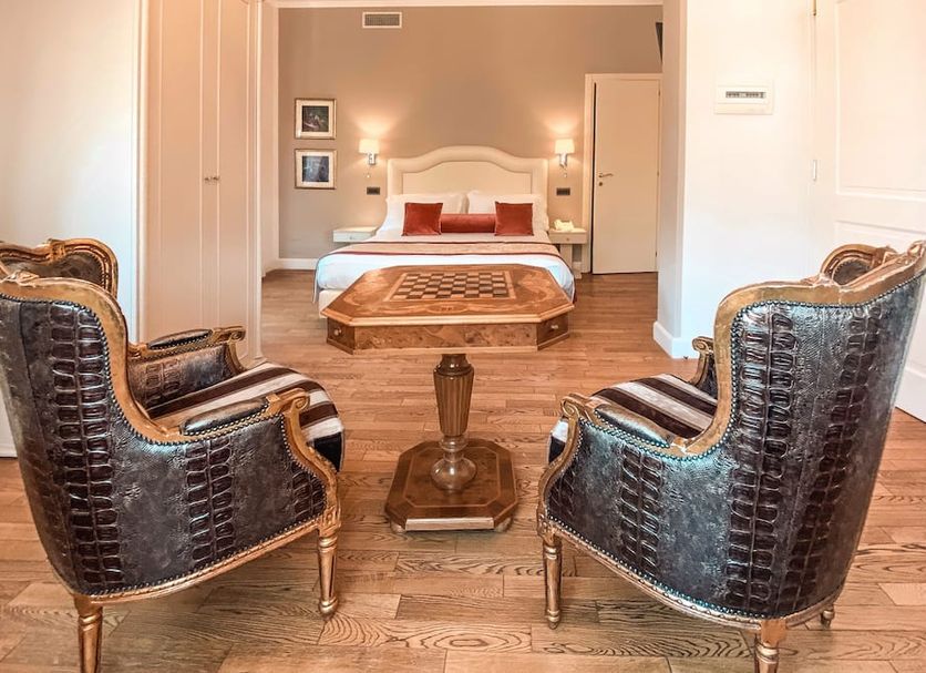 Hotel Sant'Andrea Santa Margherita Ligure guest room with ornate chairs, bed and wooden coffee table
