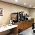 Denison Inn & Suites in Denison breakfast area with coffee station and dining tables