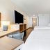 Spark by Hilton Harrisonburg University Area room with two white beds, desk, TV and hallway view in Harrisonburg