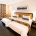 City Lodge Hotel Grandwest, Cape Town: twin beds in a standard guest room with a desk and seating area