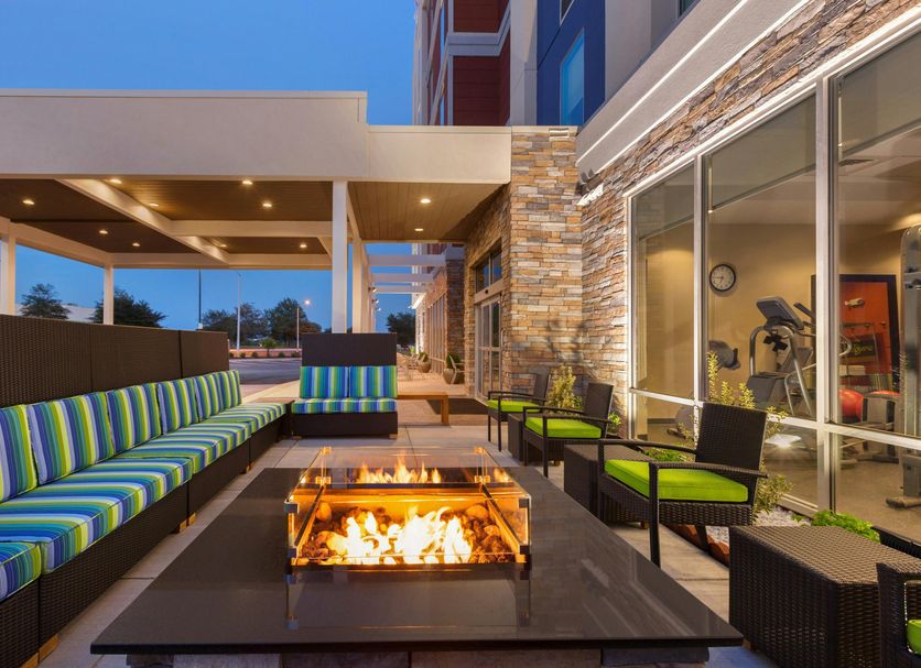 Home2 Suites by Hilton Florence patio with fire pit and striped seating at dusk