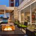 Home2 Suites by Hilton Florence patio with fire pit and striped seating at dusk