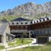HG Alto Aragón in Formigal with stone-and-wood lodge buildings below rugged mountain peaks