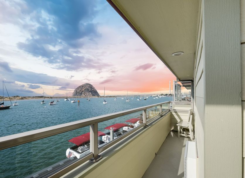 Balcony view at Estero Inn in Morro Bay overlooking the harbor and Morro Rock at sunset