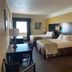 Galveston Beach Hotel in Galveston room with two double beds, desk, and window view