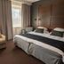 Original Sokos Hotel Vaakuna Joensuu guest room with double bed, sofa, and large windows