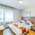 Appart'City Classic Thonon Les Bains room with twin beds, desk, window and small dining table