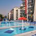 Grand Uysal Apart Hotel in Alanya with outdoor pool, lounge chairs, and apartment balconies