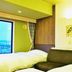 Asahikawa Park Hotel in Asahikawa guest room with twin beds and city view through a large window