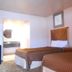 Airport Inn Downtown Phoenix guest room with two double beds and bathroom vanity