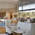 Waldorf Astoria Ras Al Khaimah lobby with white seating, piano and floor-to-ceiling windows