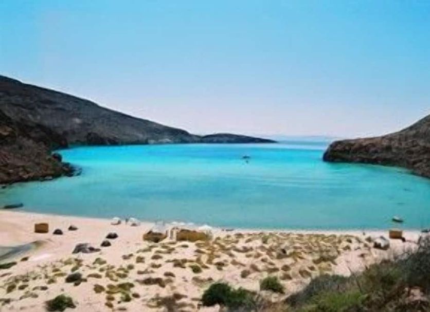 Hotel Miramar in La Paz with a sandy beach and turquoise bay framed by rocky hills