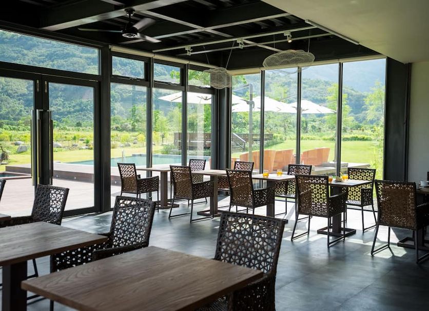 The Silence Manor in Ruisui Township dining area with mountain and garden views through floor-to-ceiling windows