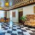 The Lalit London lobby in London with star-patterned ceiling, marble floor, and seating area