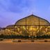 Fairfield by Marriott Bengaluru Outer Ring Road exterior at dusk with illuminated glass pavilion and landscaped grounds
