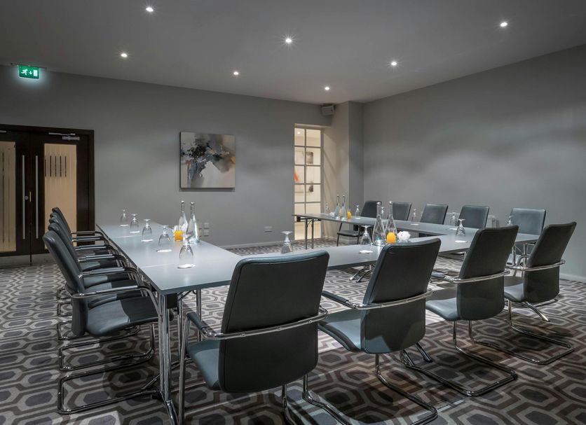 Maldron Hotel Dublin Airport meeting room in Dublin with conference table and black chairs