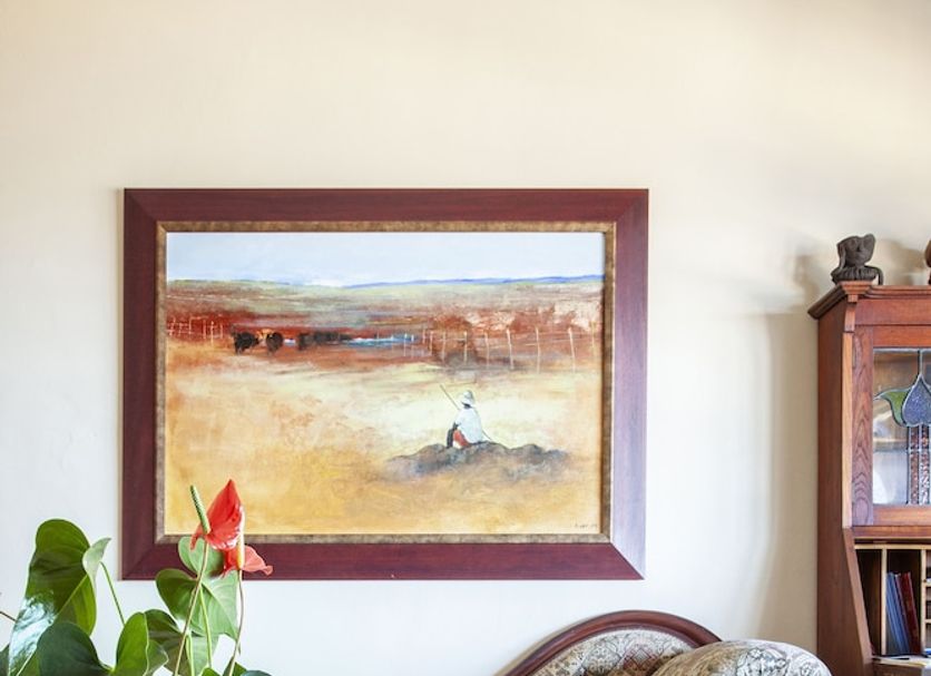 Moonglow Guest House in Simon's Town with a vintage chaise lounge, framed art, and potted plant