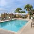 TownePlace Suites by Marriott Fort Walton Beach-Eglin AFB rooftop pool with lounge chairs and palm trees