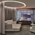 Grace La Margna St Moritz lounge with circular ceiling light, fireplace, and mountain view window in St. Moritz