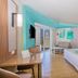 Riu Palace Antillas Adult Only room in Noord with balcony door, sofa, desk and king bed
