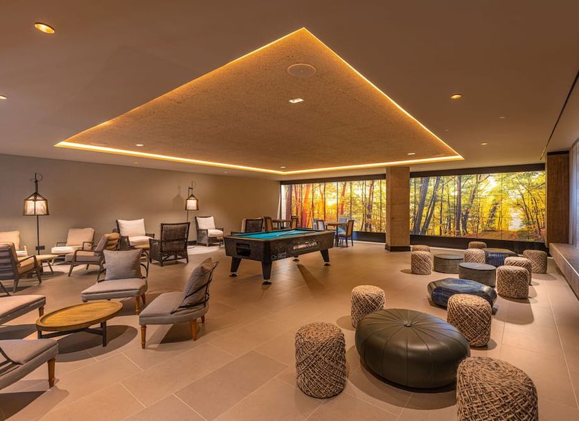Hotel Faro, a Lopesan Collection Hotel - Adults Only lounge with pool table and floor-to-ceiling windows in Maspalomas