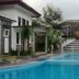 Poolside view at Seulawah Resort And Cafe in Batu with a terrace, steps, and lush greenery
