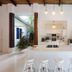 Le Cameleon Boutique Hotel kitchen with white island and stools, open airy interior in Puerto Viejo de Talamanca