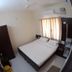 Sr Residency in Tiruchirappalli guest room with double bed, window curtains, and ceiling fan