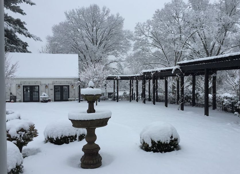 The Connecticut River Valley Inn in Glastonbury, snow-covered courtyard with trees and patio