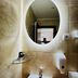 Side One Design Hotel Garni, Belgrade: modern bathroom sink with illuminated oval mirror and wall shelf