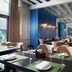 Minsk Marriott Hotel in Minsk, modern hotel restaurant with white chairs, blue walls and large windows