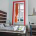 Pal's Mini Hostel Budapest room with bed, small dining table and window view