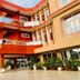 Golden Key Hotel in Accra exterior with orange balconies, entrance, and parked car