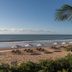 Pousada Estrela D' Agua in Trancoso with beach, ocean view, umbrellas, and palm fronds