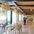 The Beach Resort & Residence - Sha Plus in Pathio restaurant with wooden tables and woven pendant lights