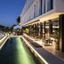 Memmo Principe Real Lisbon rooftop pool terrace with glass railing and city views at dusk