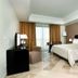 Concorde Paris, Tunis: guest room with king bed, desk, lamps, and balcony doors